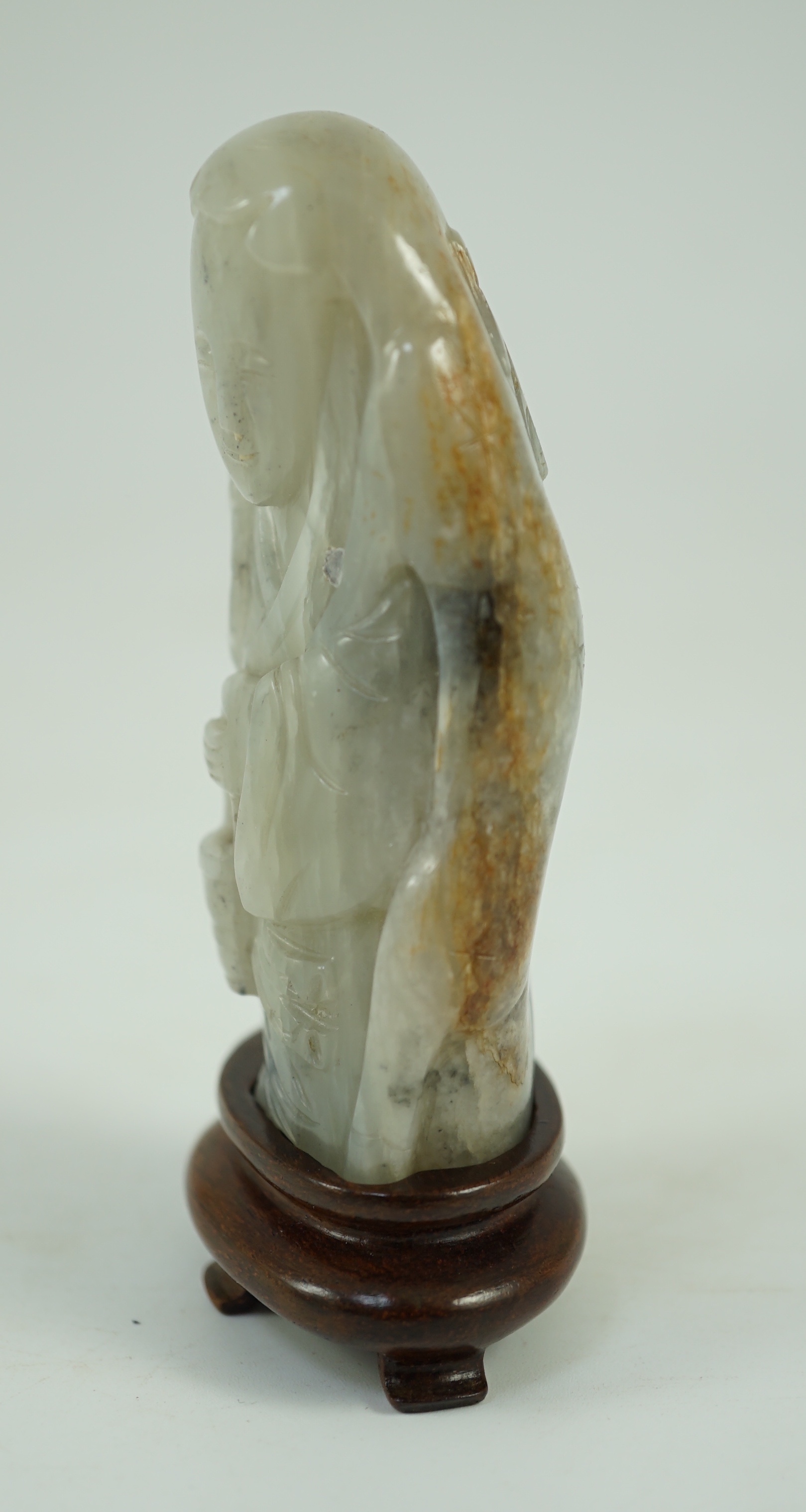 A Chinese white, grey and russet jade figure of Zhou Yanzi, Ming dynasty, 8.5cm high, Filled hole to figure, wood stand